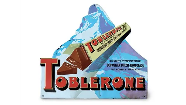 1970s ad of Toblerone package opened with the backdrop of matterhorn mountain in the background.