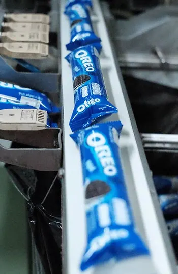 Packages of Oreo cookies running along an assembly line"