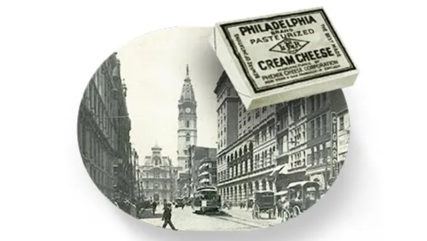 Picture from 1880 of Philadelphia and a package of Philadelphia cream cheese in the foreground also from that time.