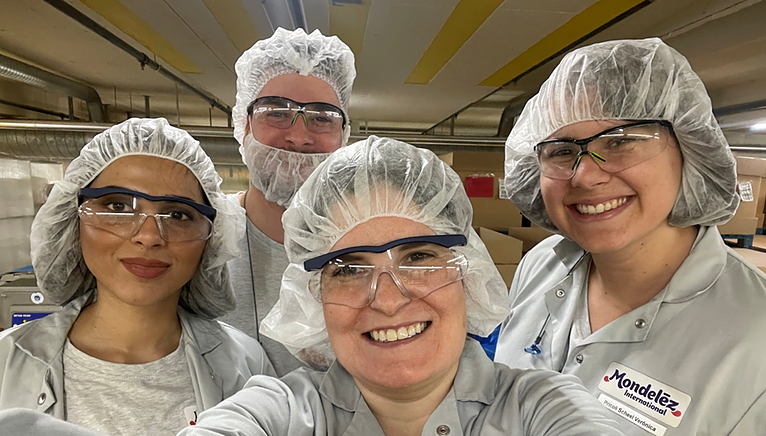 Vanessa in lab coat with team