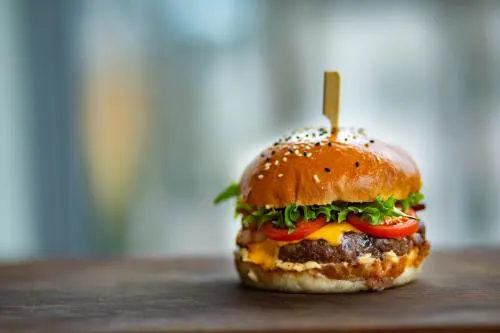 photo-of-juicy-burger-on-wooden-surface-1639565