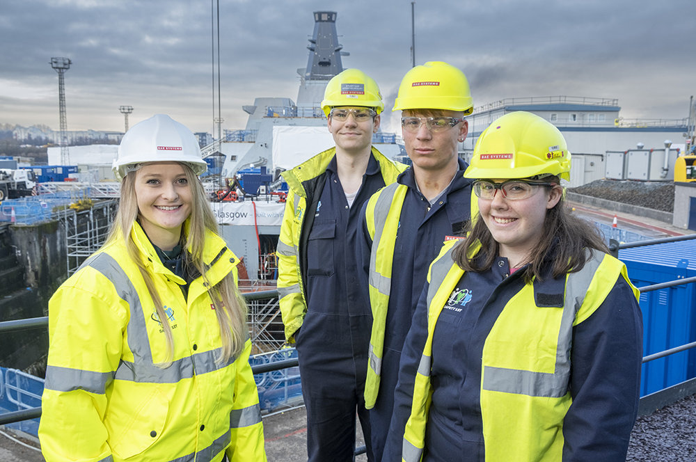 Four BAE Systems apprentices at a ship yard