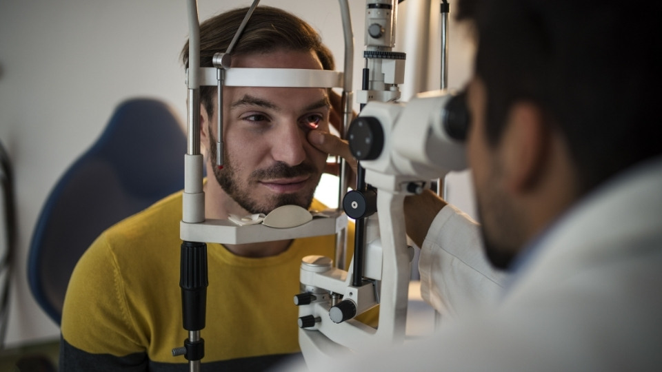 A man getting his eyes tested by an optometrist.