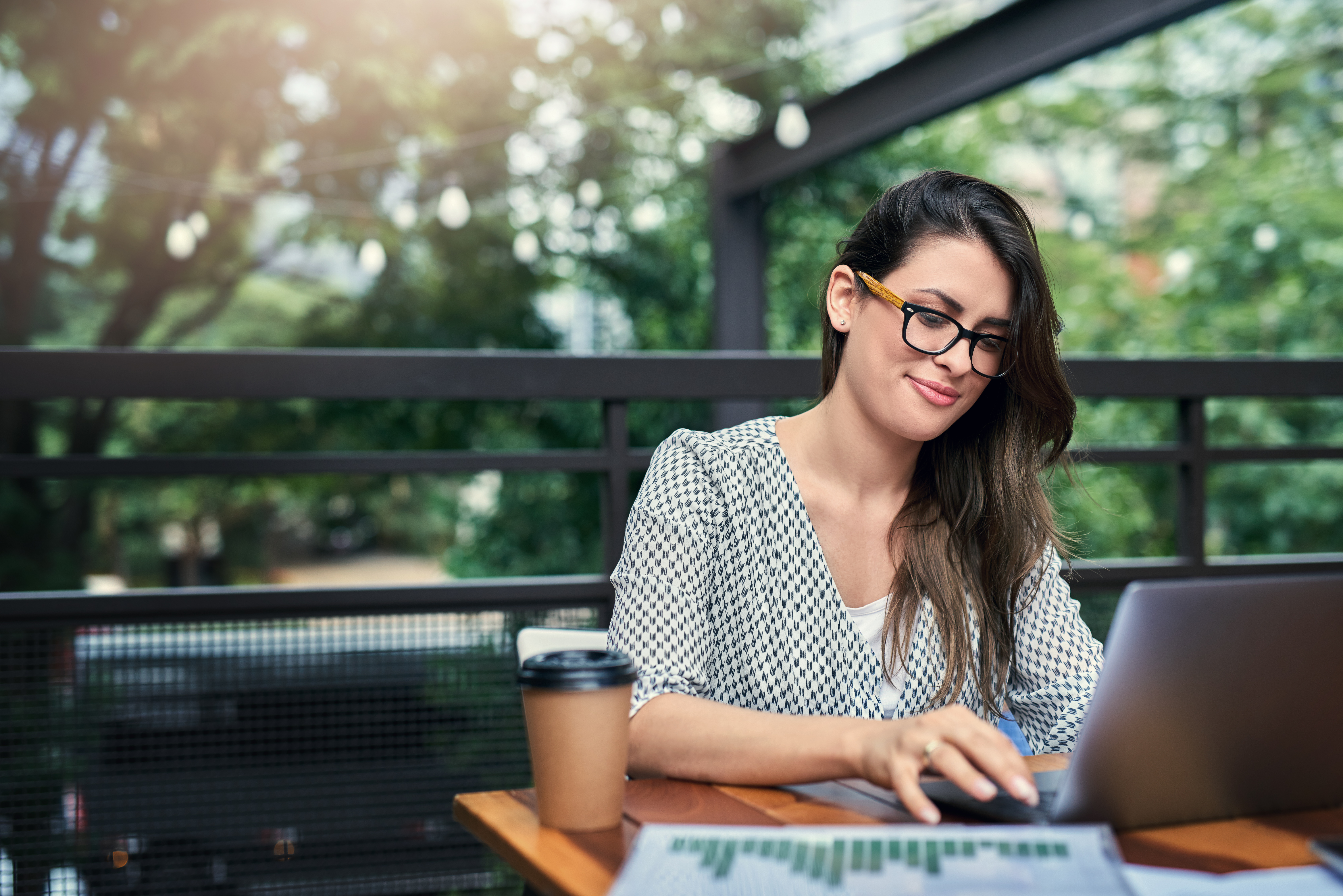 A woman using a laptop outside