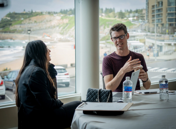 An nib employee workshopping thoughts on paper