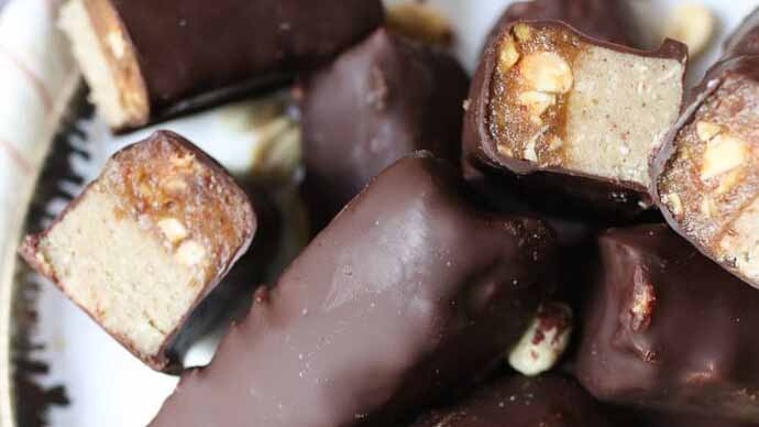 Close up of the inside of a healthy chocolate, caramel and biscuit bar.