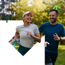 Two people running through a park.