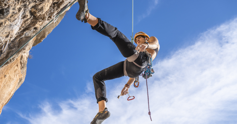 A person abseiling wearing a helmet