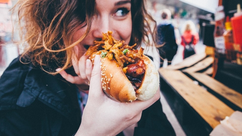 A woman eating a hotdog