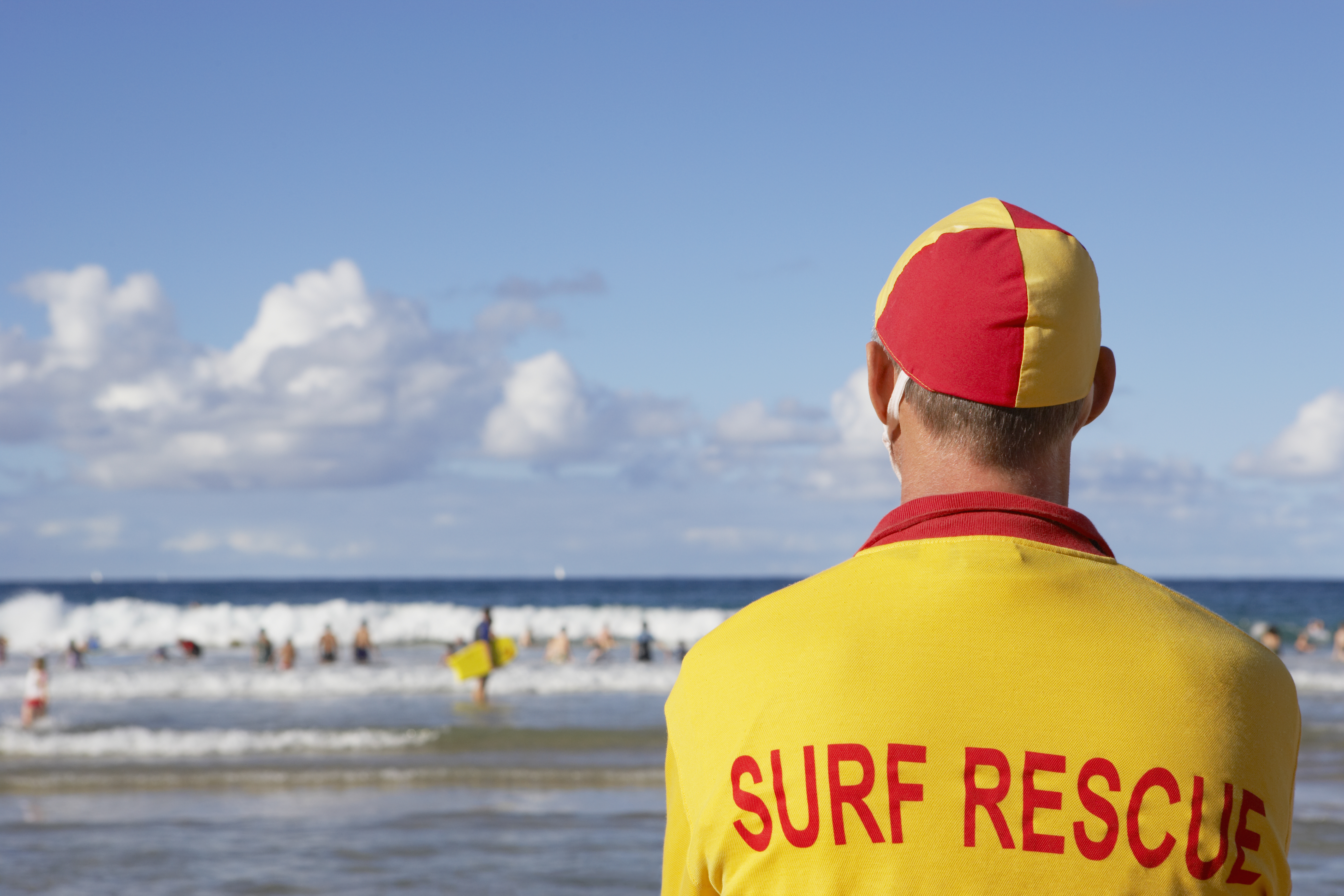 Lifeguard at beach staring at ocean