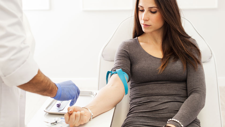 A young woman having her bloody pressure taken.