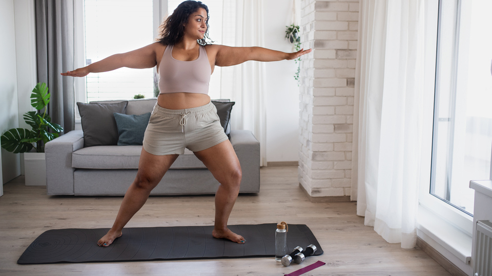 Woman doing yoga at home.