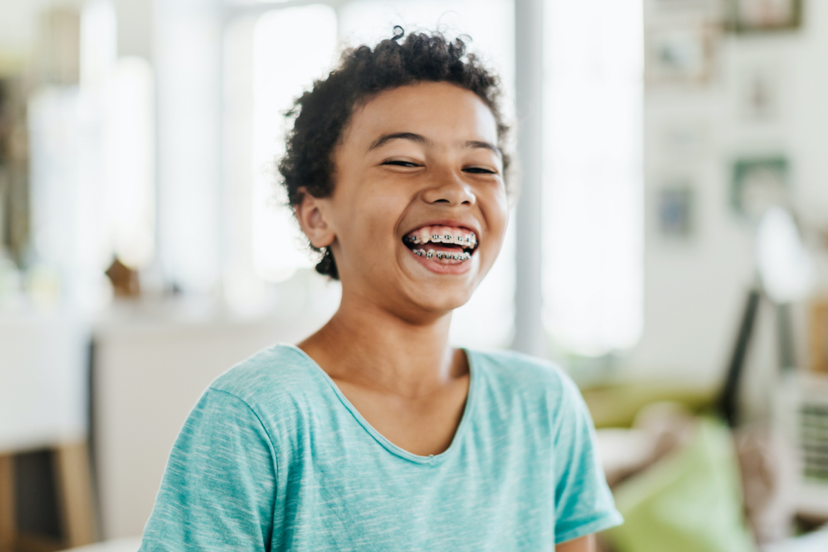 A laughing person with braces
