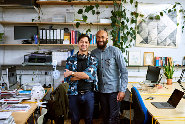 Two male employees smiling