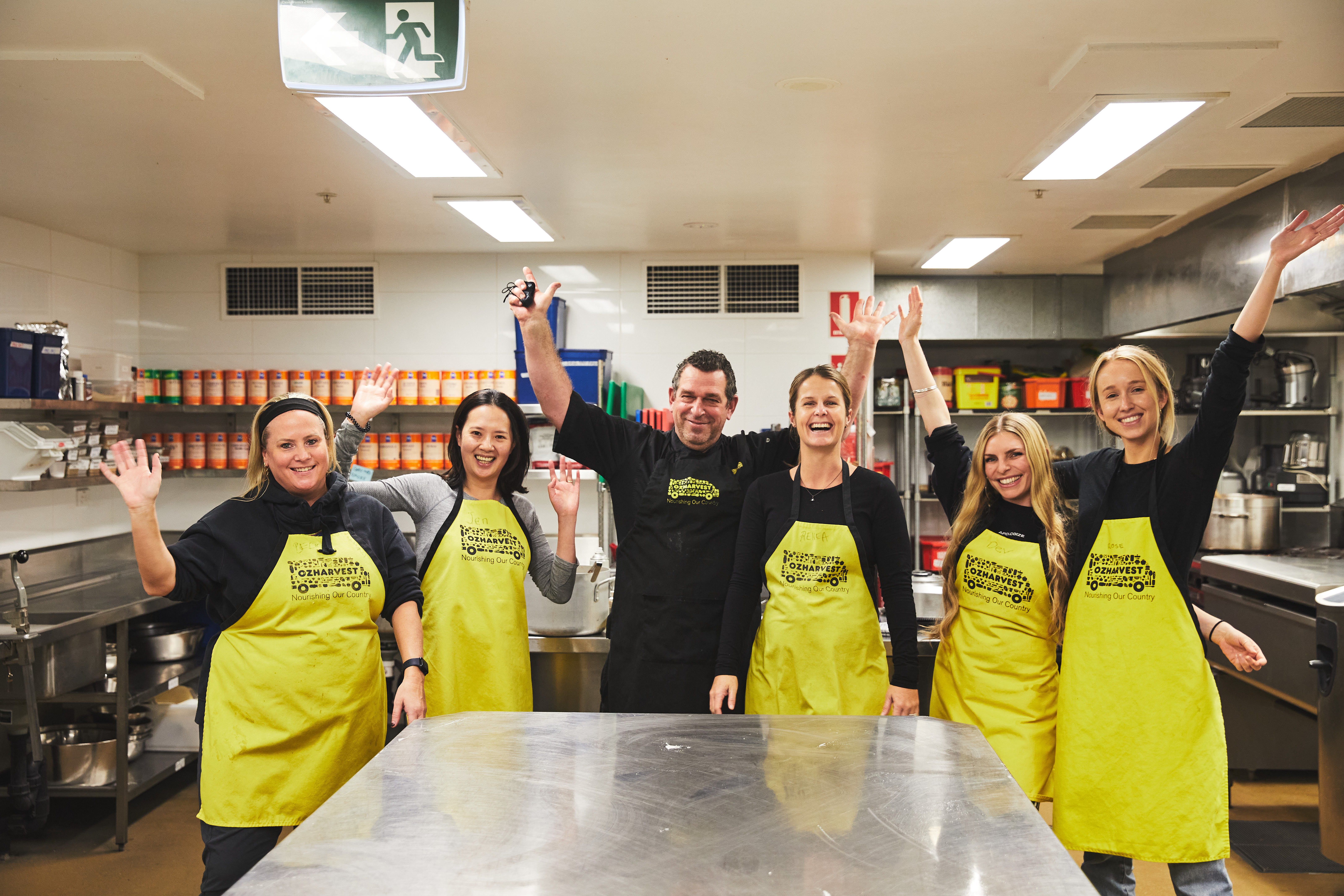 nib staff members helping at an OzHarvest kitchen.