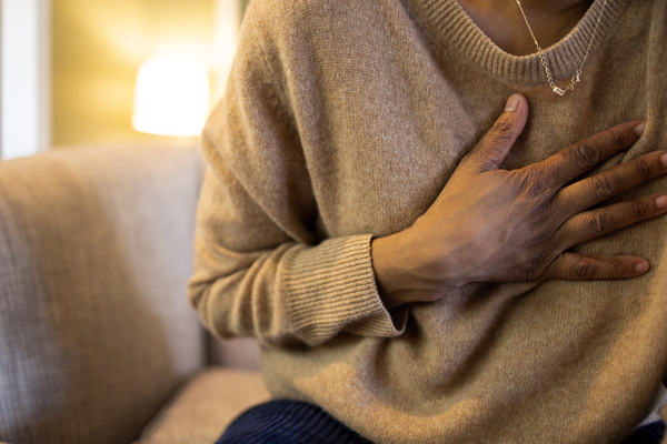 A woman clutching her chest
