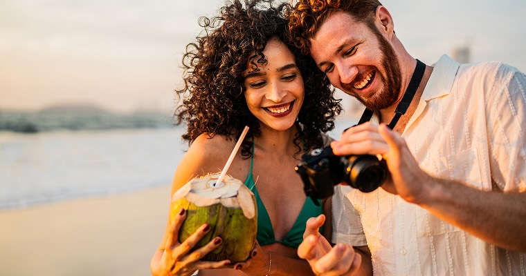 A smiling couple looking at a camera