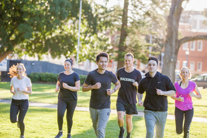 Group of adults running in a park