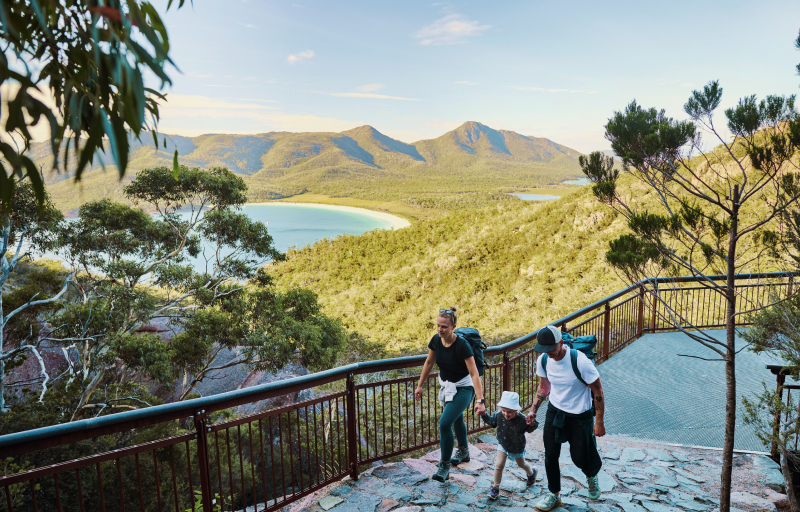 Bushwalking young family in Tasmania, Australia taking in the view at Freycinet NP