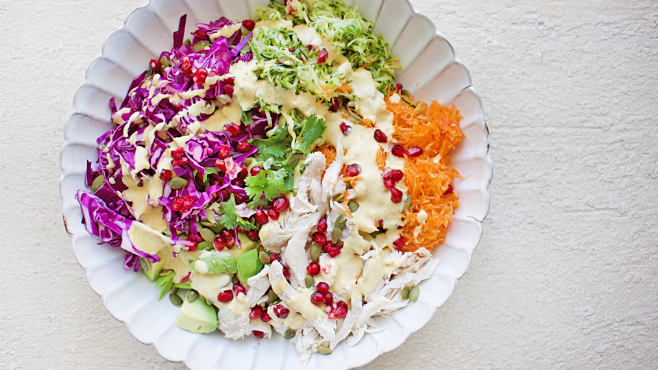 Rainbow salad with chicken, carrot and red cabbage in a bowl.