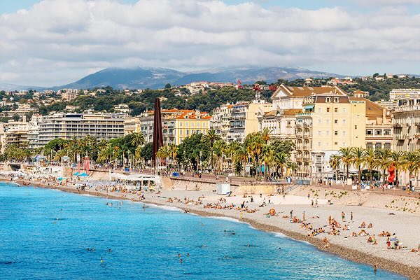 Beach with turquoise sea water along Promenade des Anglais, Nice, France