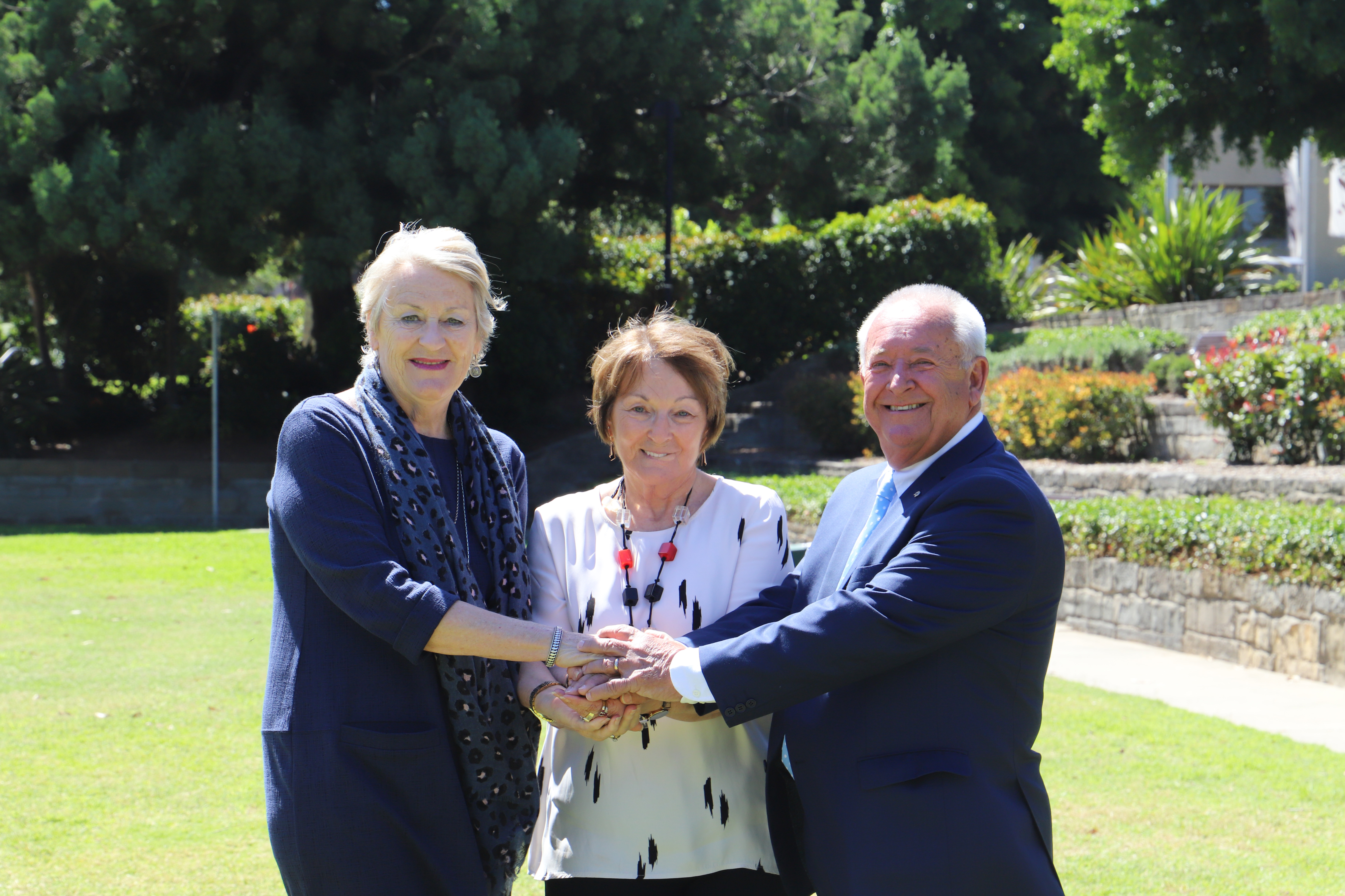 Newcastle Permanent Charitable Foundation representatives linking hands