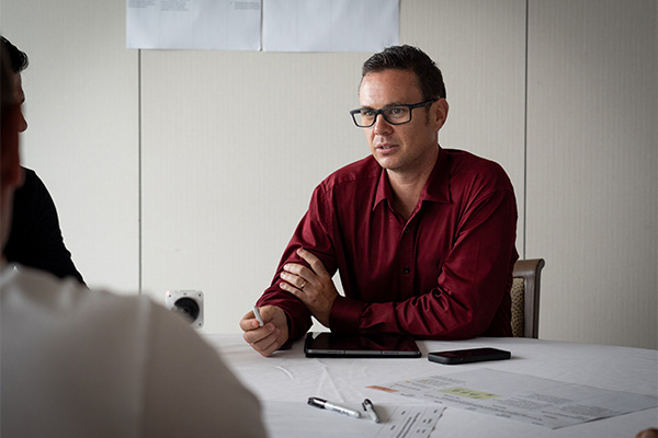 A male nib employee engaging in conversation at a catch up