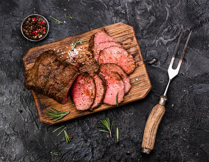 Roast beef on a timber chopping board