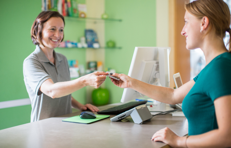 Woman attending customer at dental pharmacy