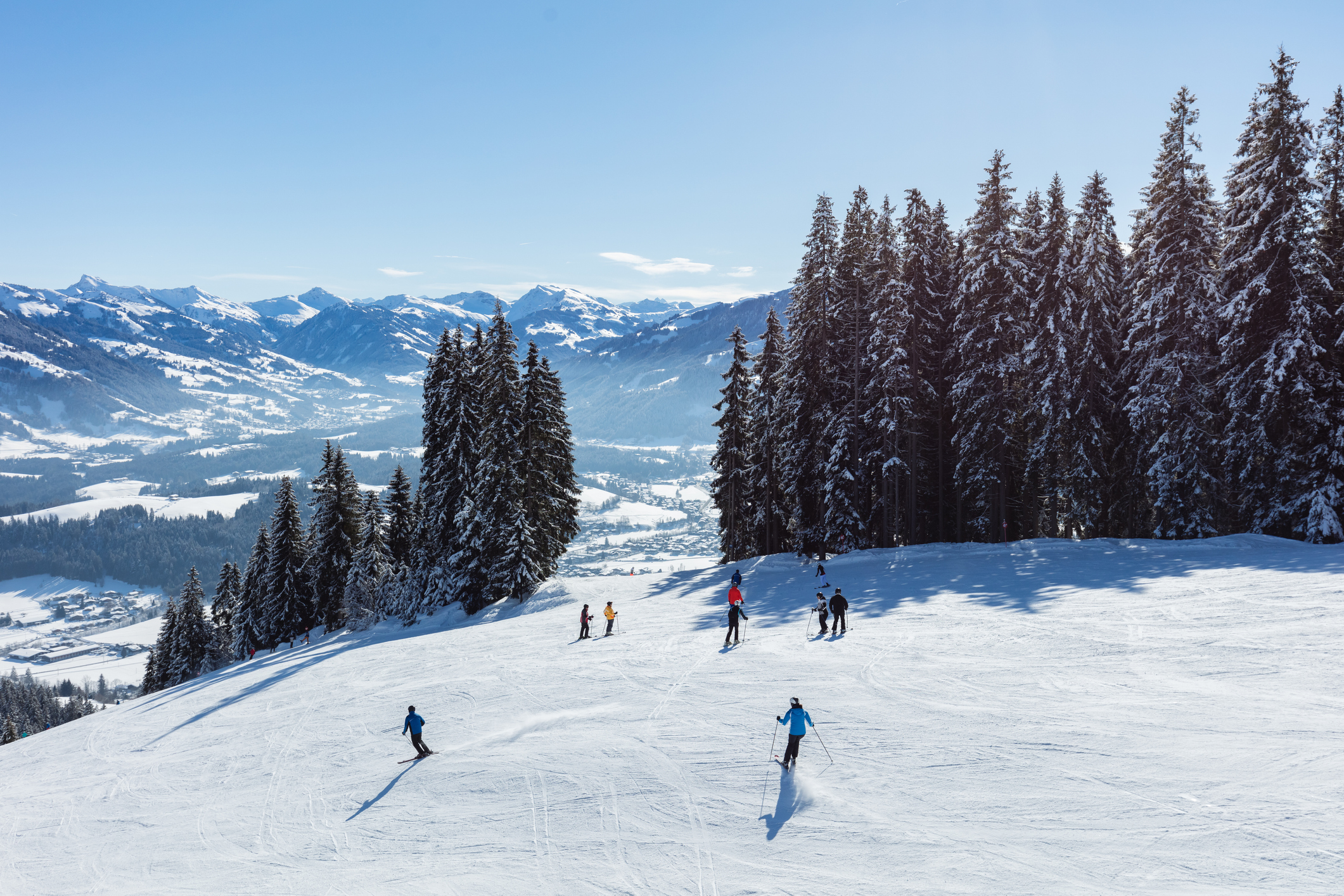 Skiiers in the Dolomites mountains on a beautiful sunny day in Italy