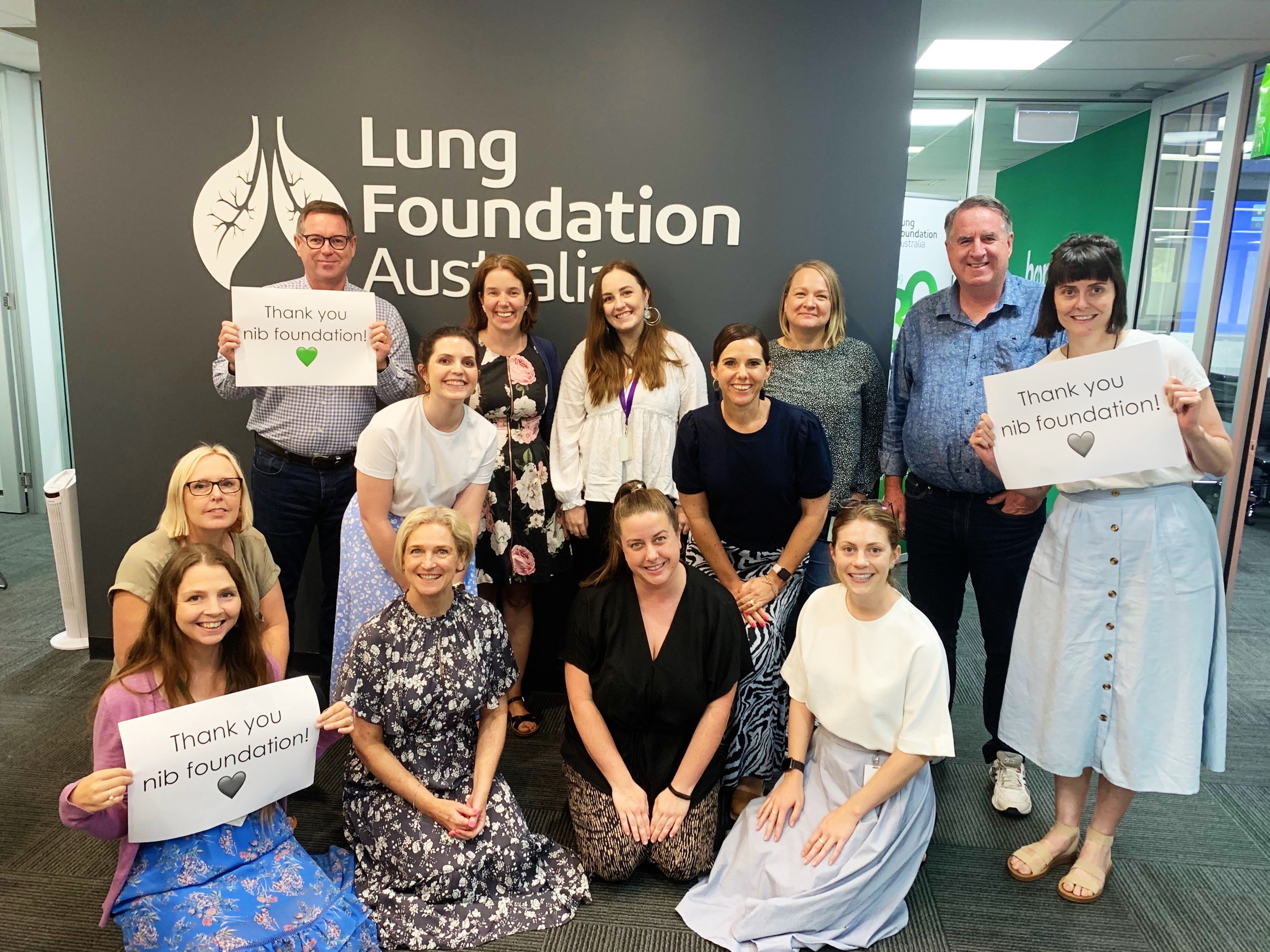 Lung Foundation Australia representatives holding up signs that say 'Thank you nib foundation!'