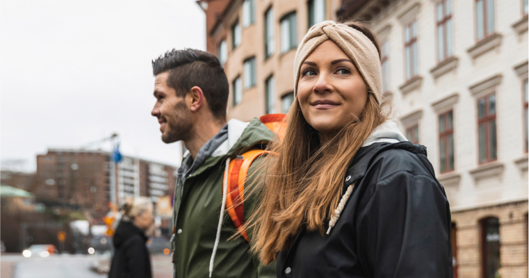 A man and a woman walking down a street