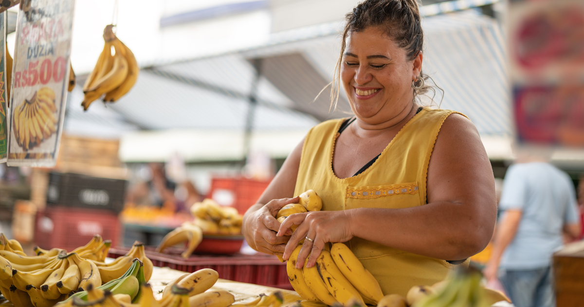 Woman selling bananas at a market.