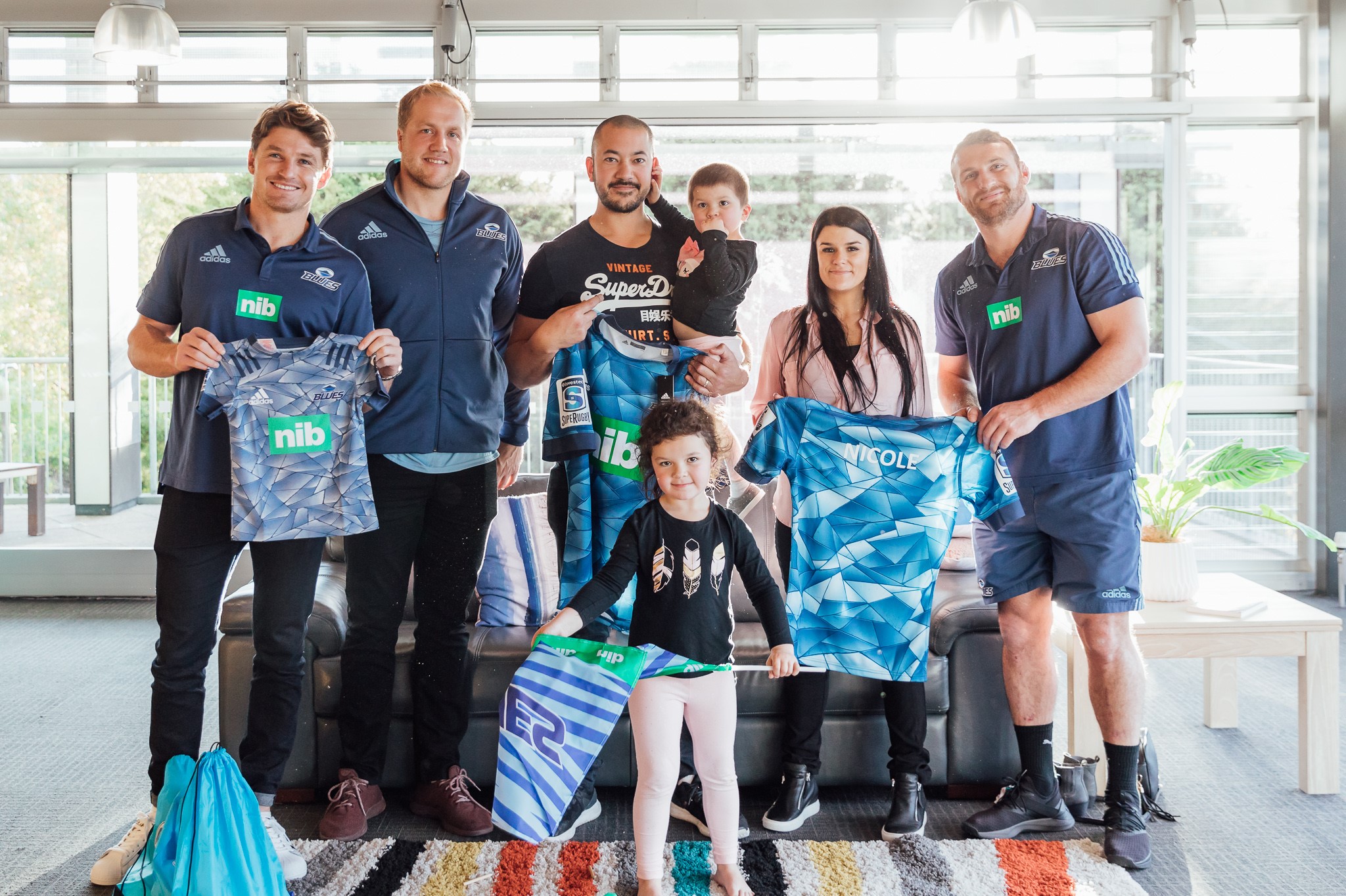 Rugby players visiting a family at a Ronald McDonald House