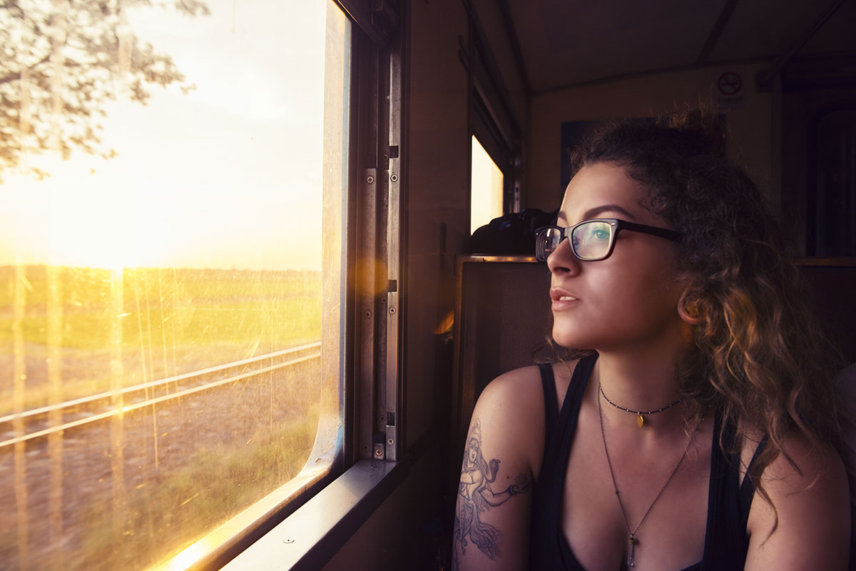 Person on a train looking out the window.