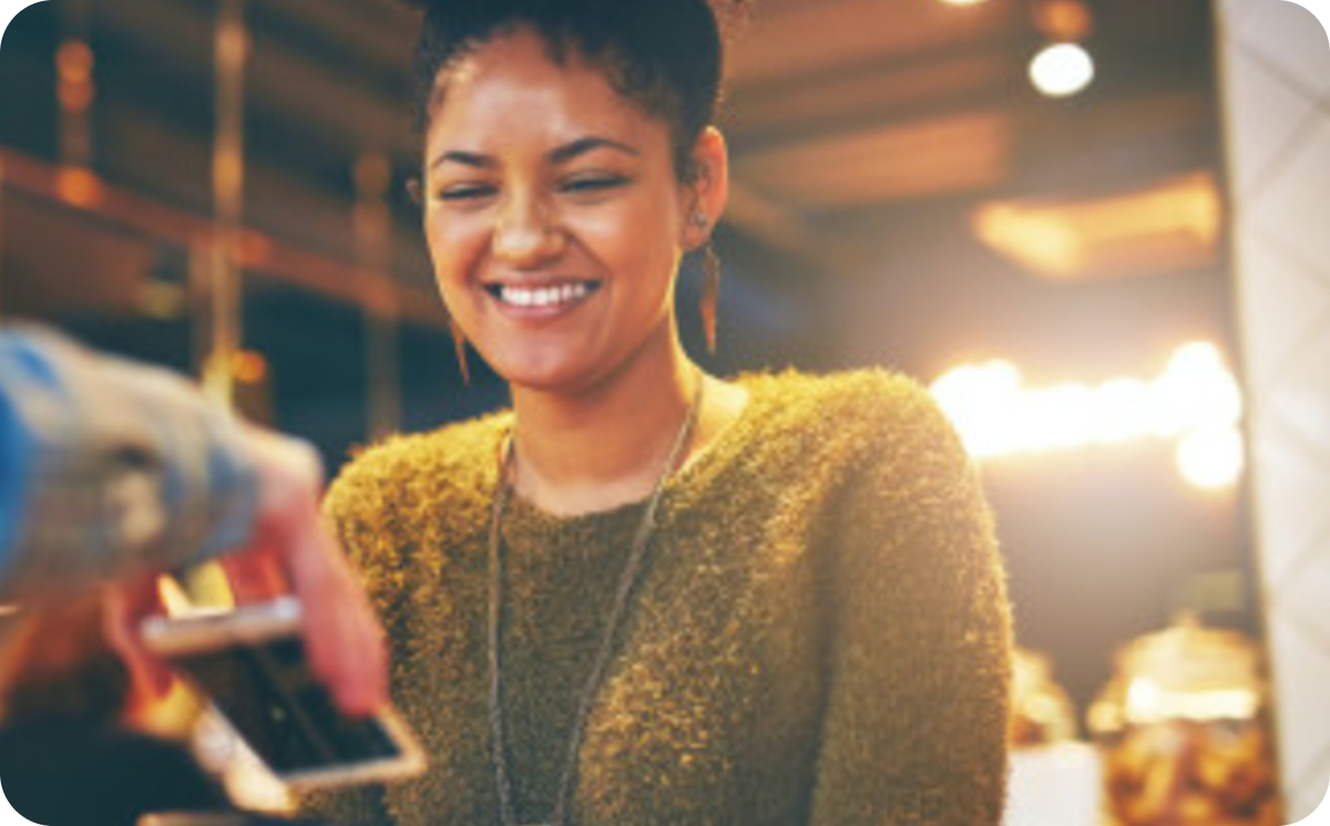 Woman paying using her phone