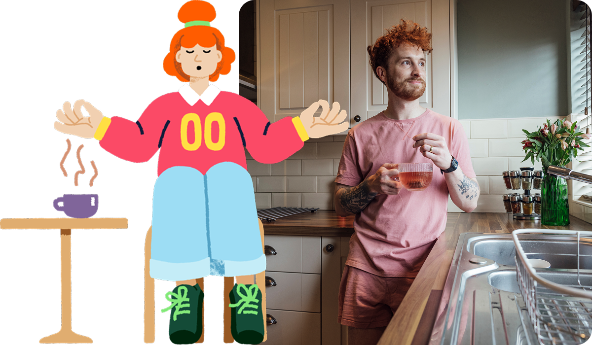 A man holding a cup of tea in a kitchen