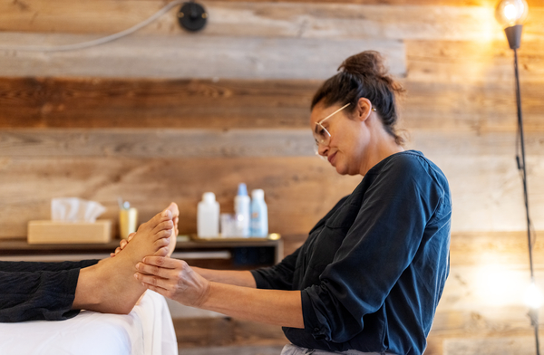 Podiatrist examining a patient's feet.