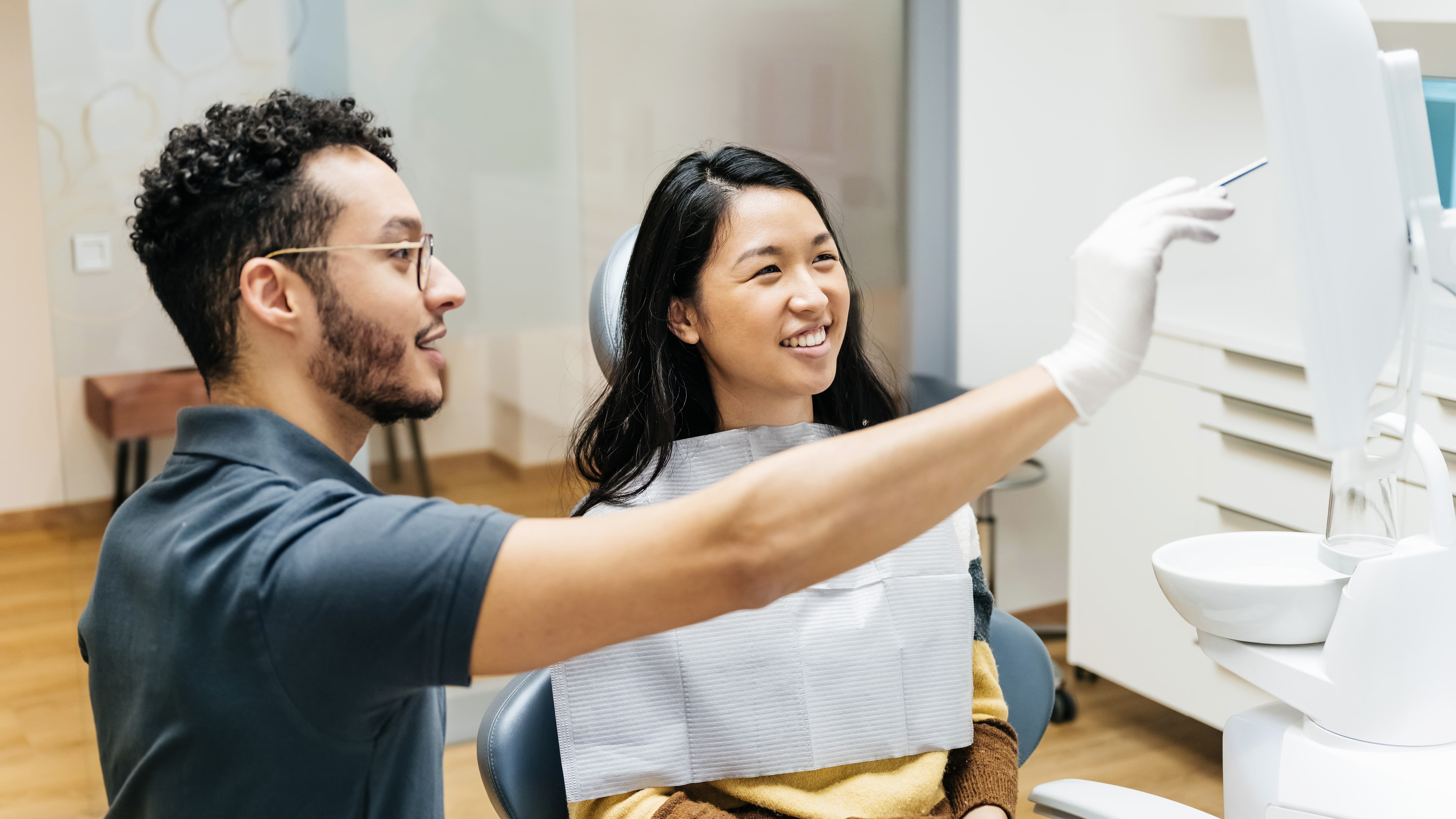 Patient talking to dentist during dental check up.