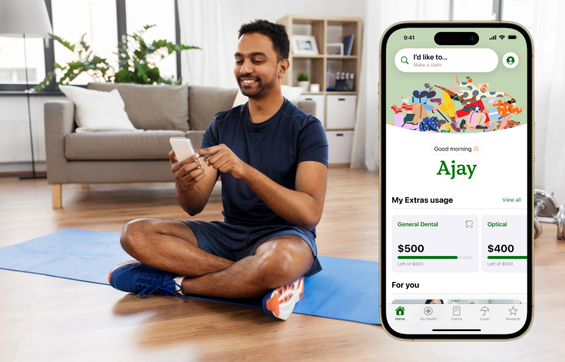 Male on his phone sitting on a yoga mat
