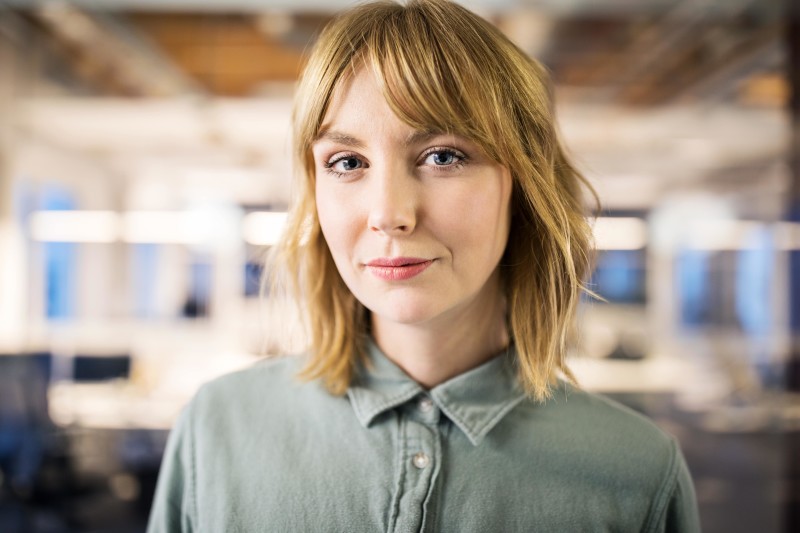 Portrait photograph of young business person in an office.