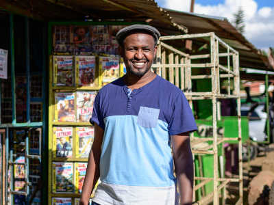 Ben smiling outside of a newsstand in Nairobi, Kenya
