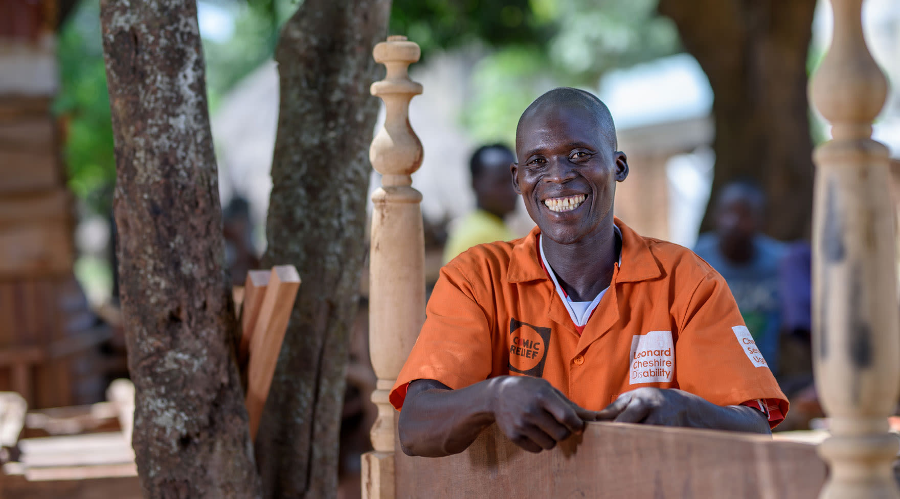 Smiling man poses with furniture