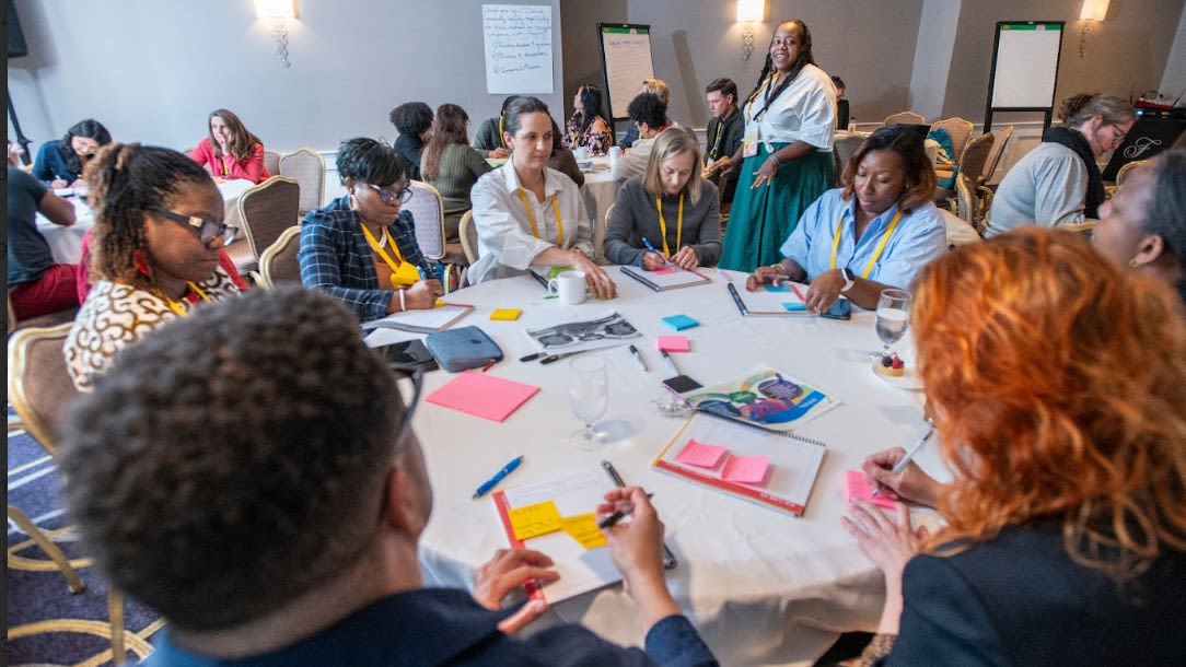 Participants sat around a table making notes