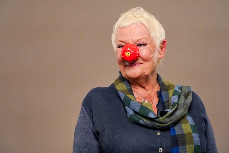 Dame Judi Dench wearing a red nose