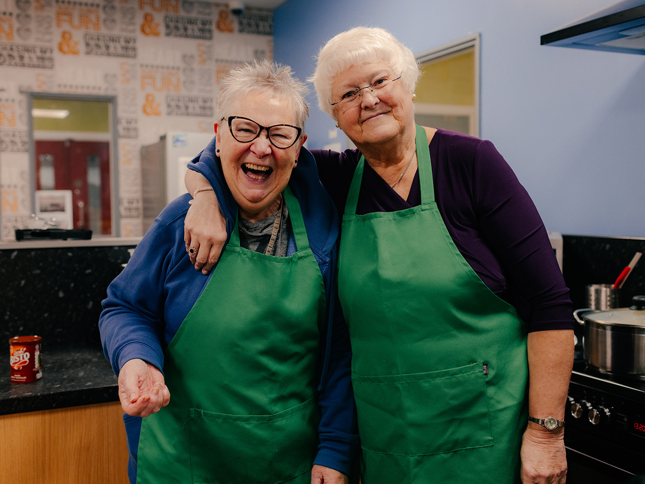 Two women at the Lighthouse project smiling at the camera