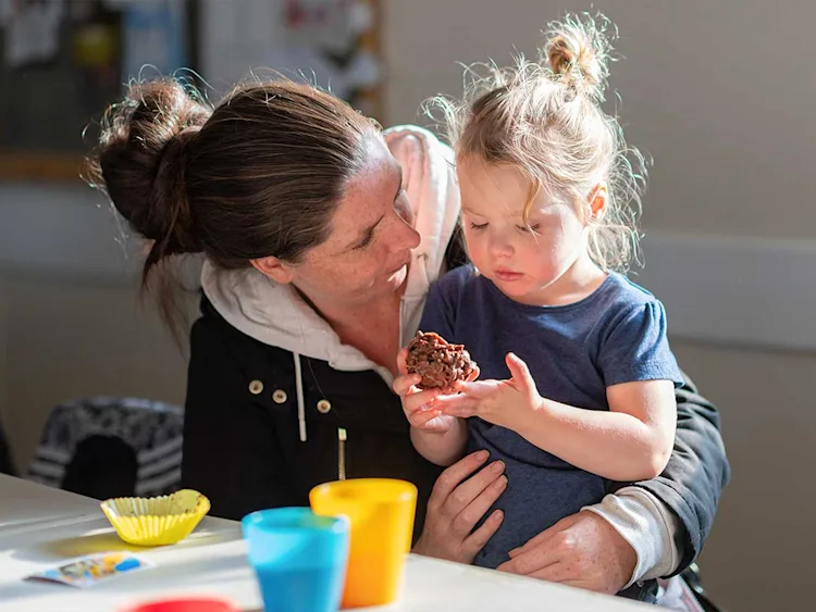 a parent talking to their toddler
