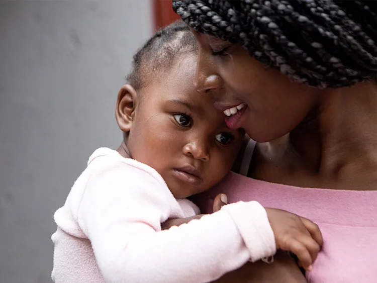 A mum holding her baby.