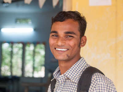 Student smiling inside of a school
