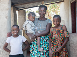 A family standing in front of their house.